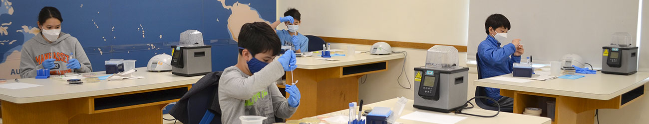 students in masks working in a laboratory